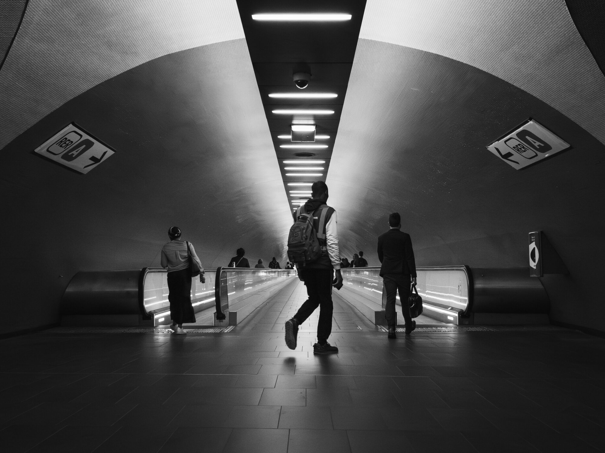 Minimalist photo of people in a Paris metro tunnel