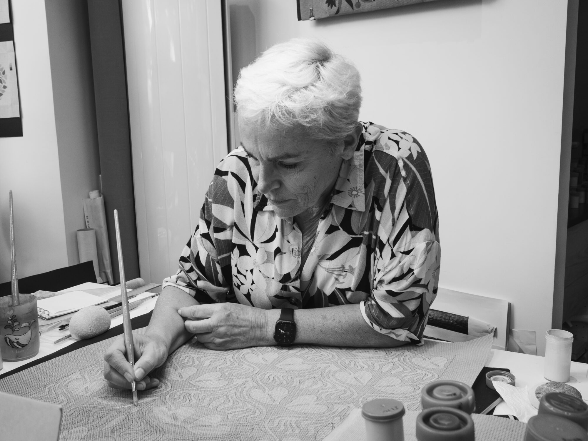 Woman looking focused while painting fabric