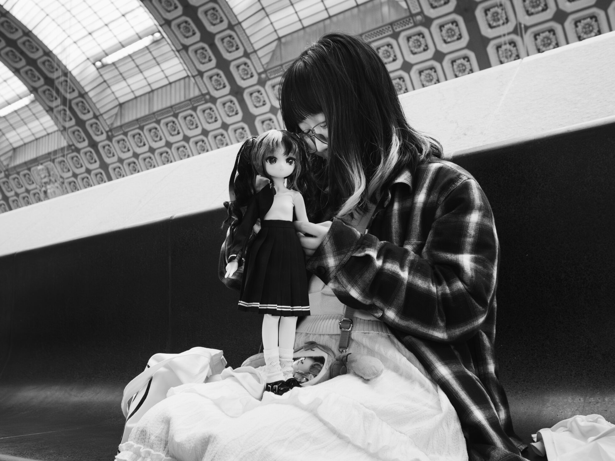 Japanese woman holding a doll dressed in a sailor suit