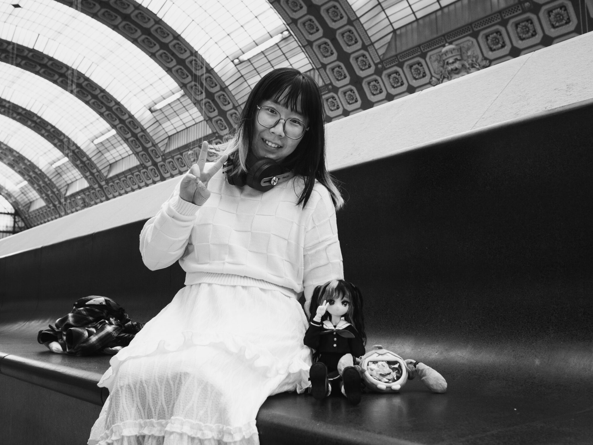 Woman and doll in a sailor suit in matching poses for the camera