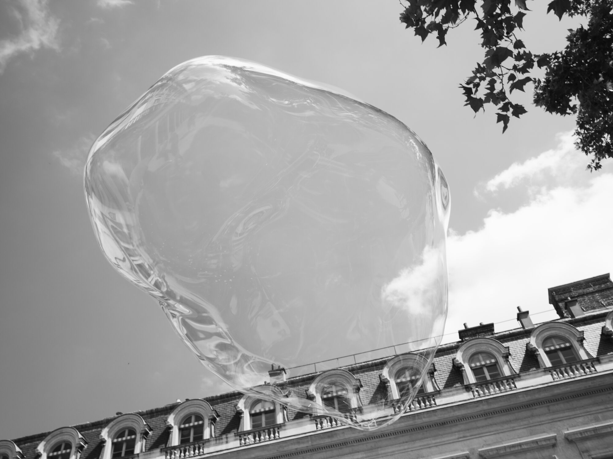 Enormous bubble floating near the Paris rooftops
