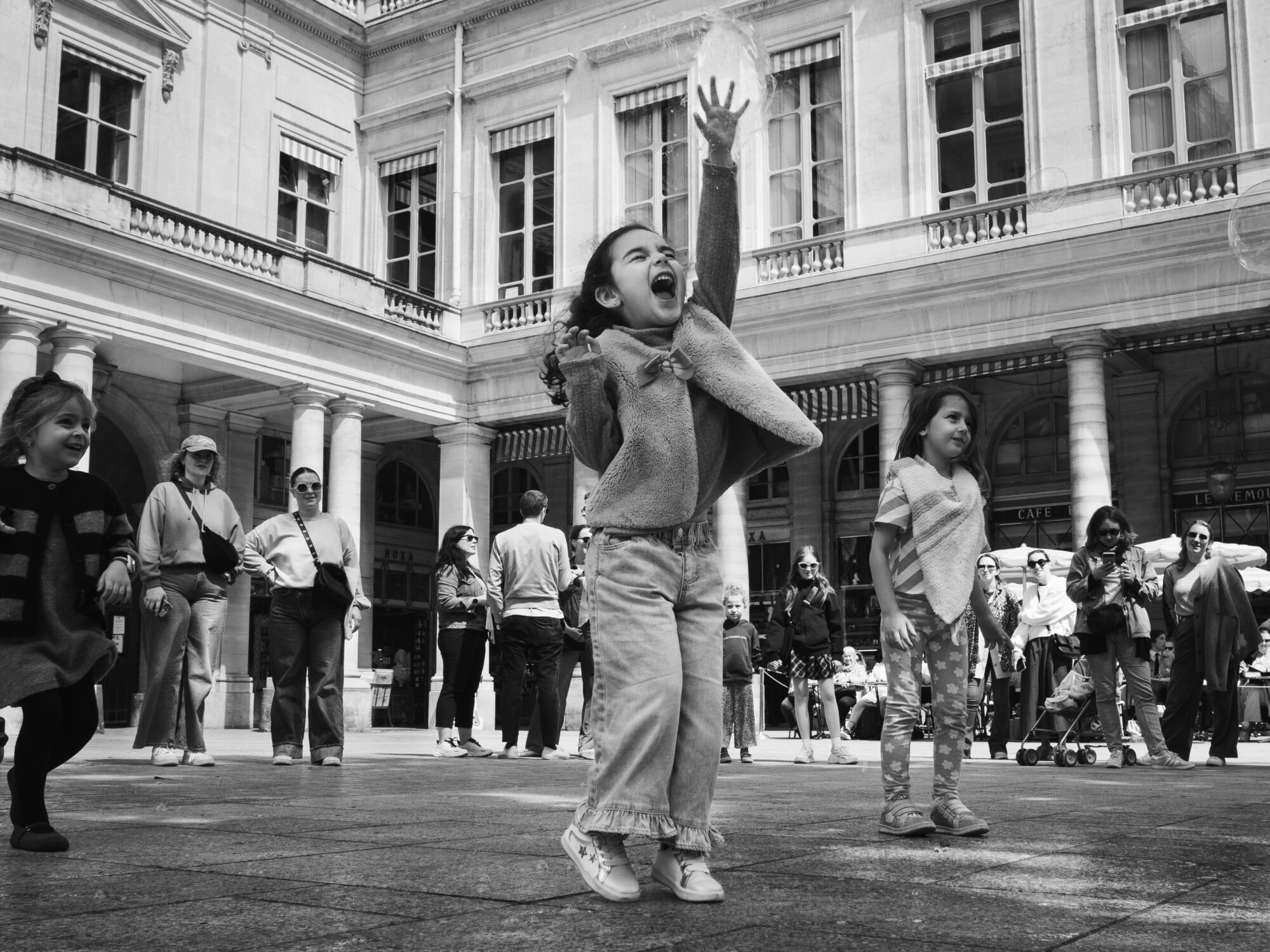 Girl squealing with delight popping a giant bubble